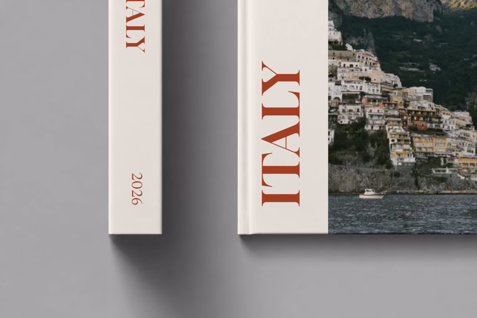 Italy hardcover photo book with the Editorial cover, shown close up beside its spine on a pale grey studio surface