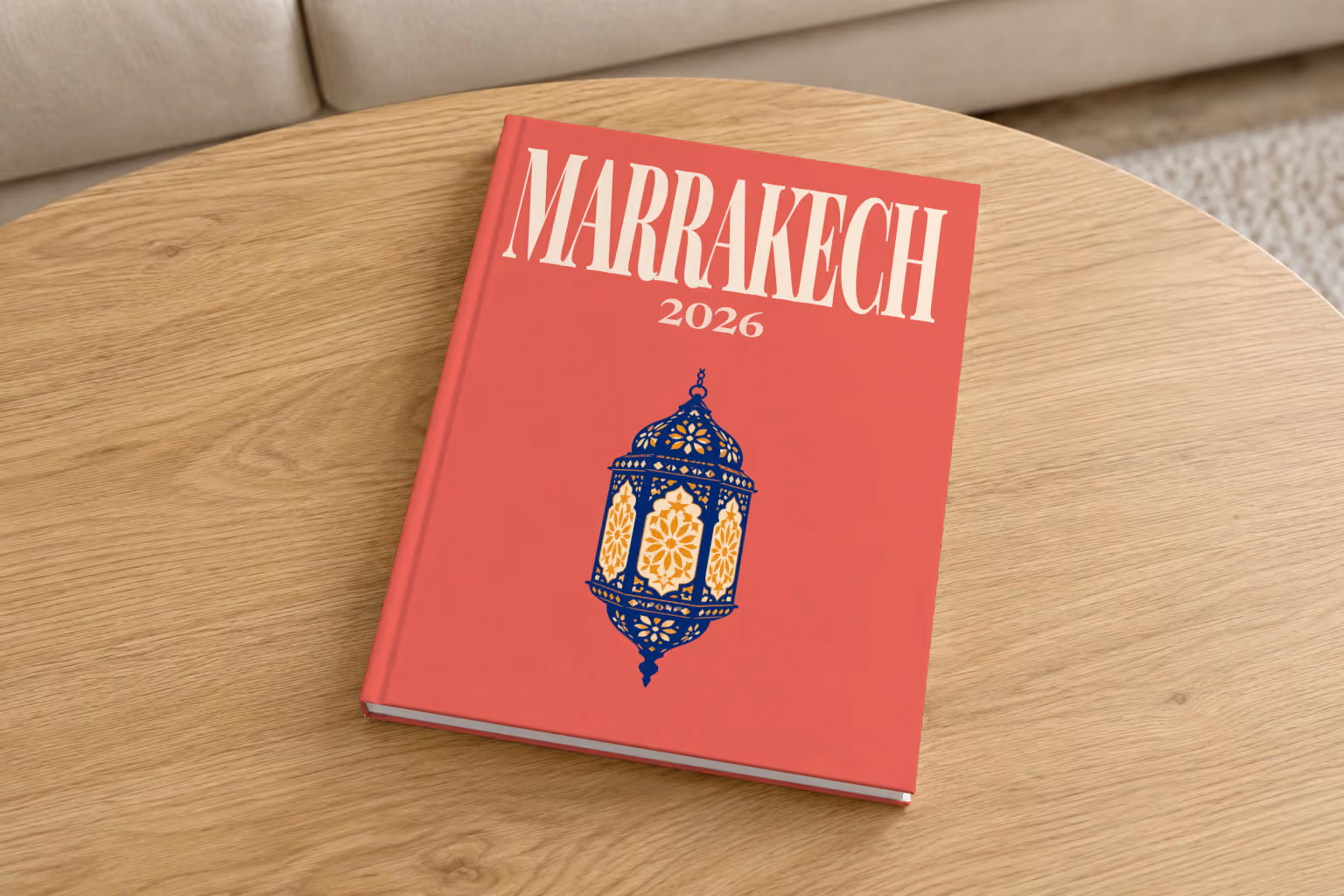 Marrakech hardcover photo book with an illustrated cover of a Moroccan lantern, on a round oak coffee table in a bright living room