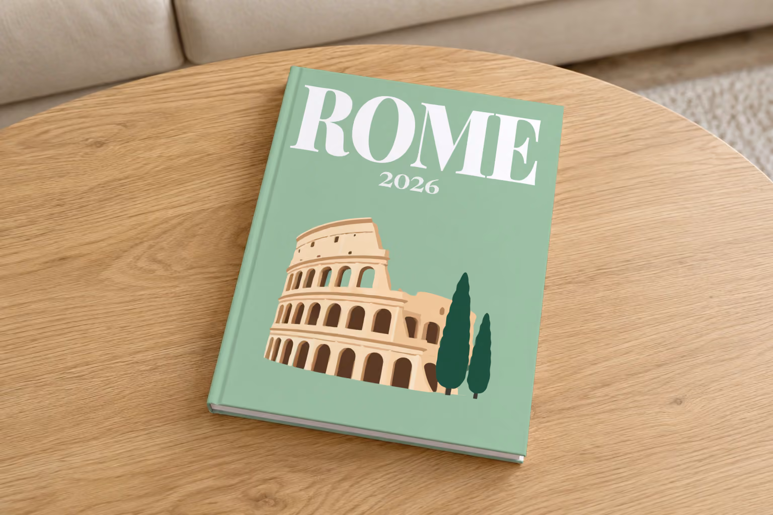 Rome hardcover photo book with an illustrated cover of the Colosseum and cypress trees, on a round oak coffee table in a bright living room