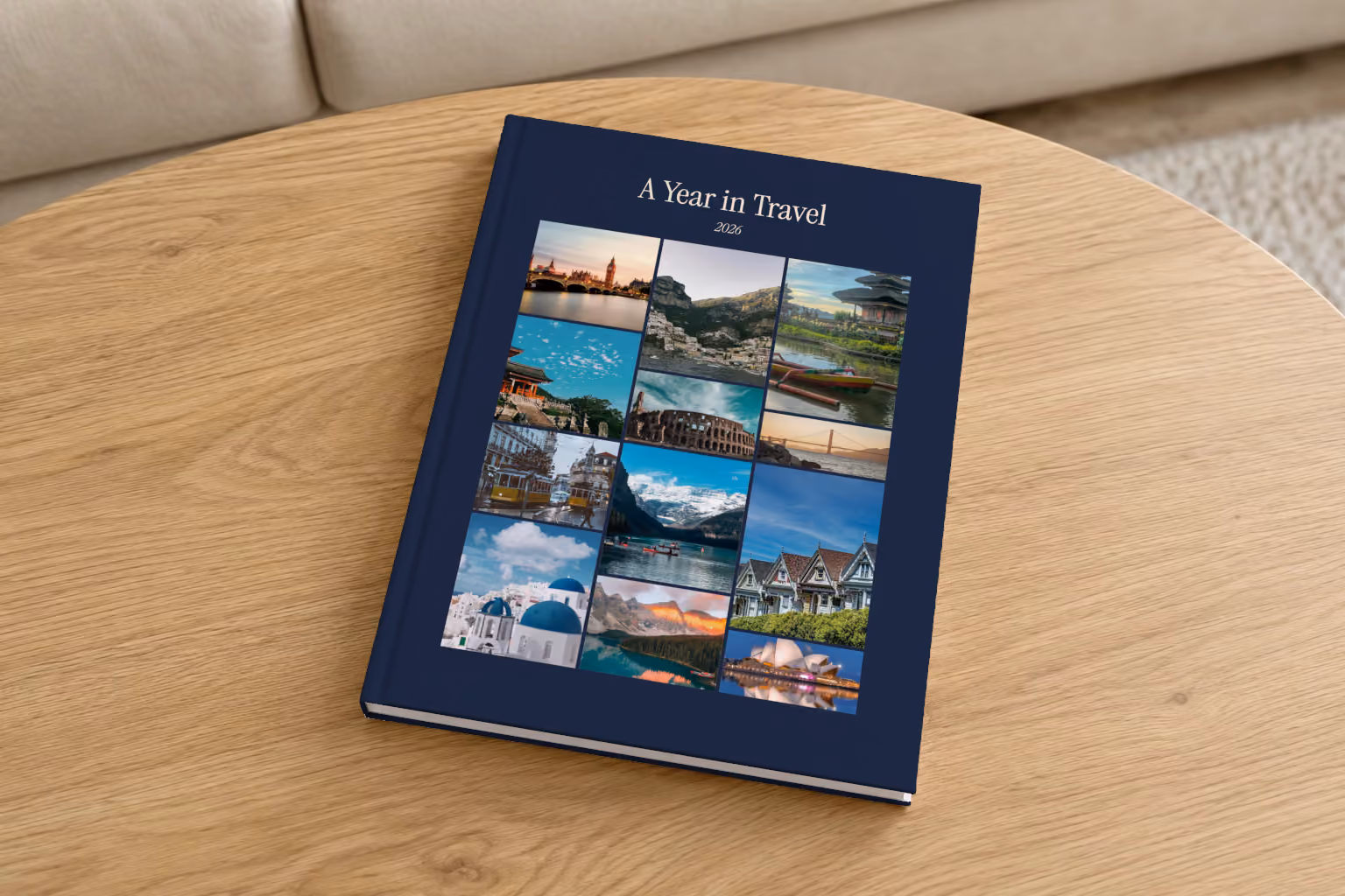 Mosaic III year in review hardcover photo book, a navy cover with a mosaic of travel photos, on a round oak coffee table in a bright living room