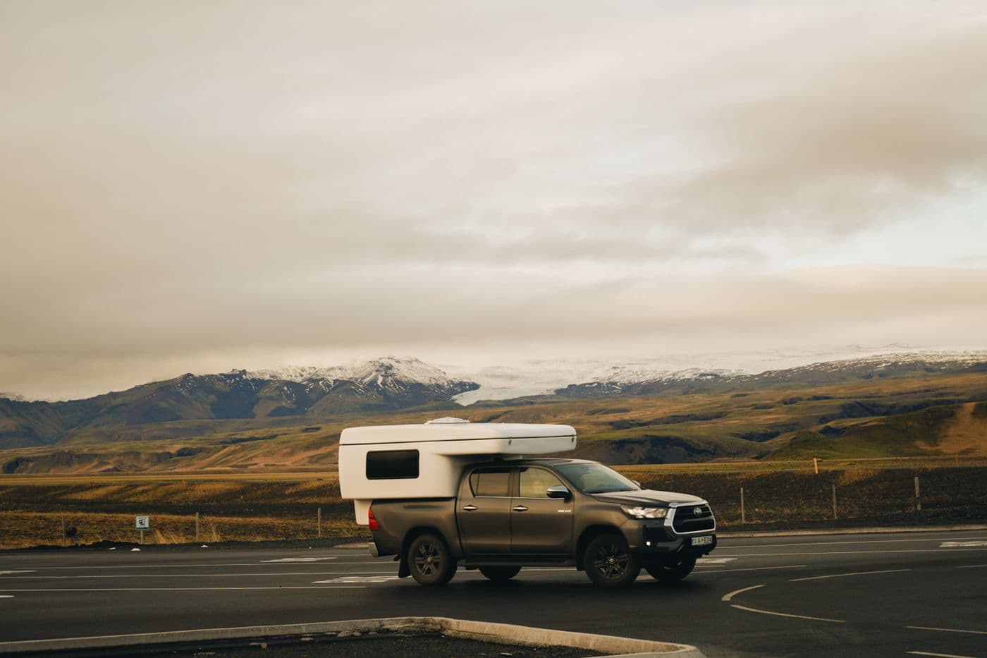A campervan crossing a dramatic Icelandic landscape