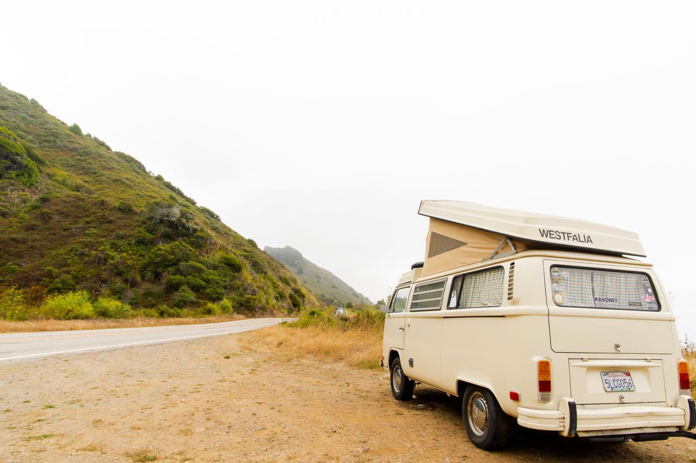 Classic campervan beside a coastal road during a van life journey
