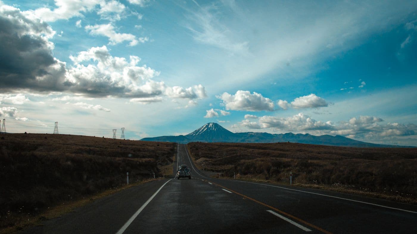 An open road leading toward a distant mountain
