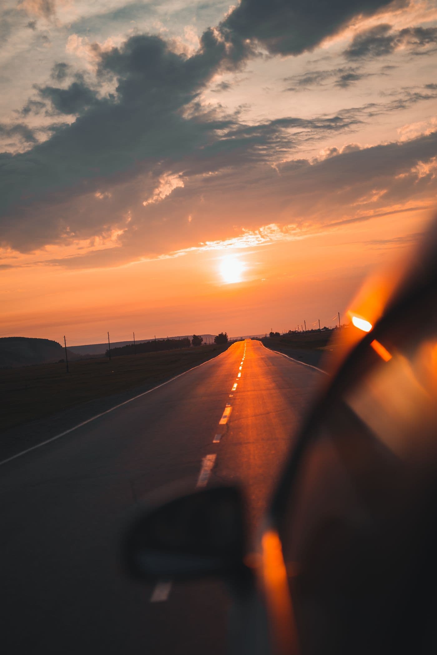 A road trip continuing into a warm sunset