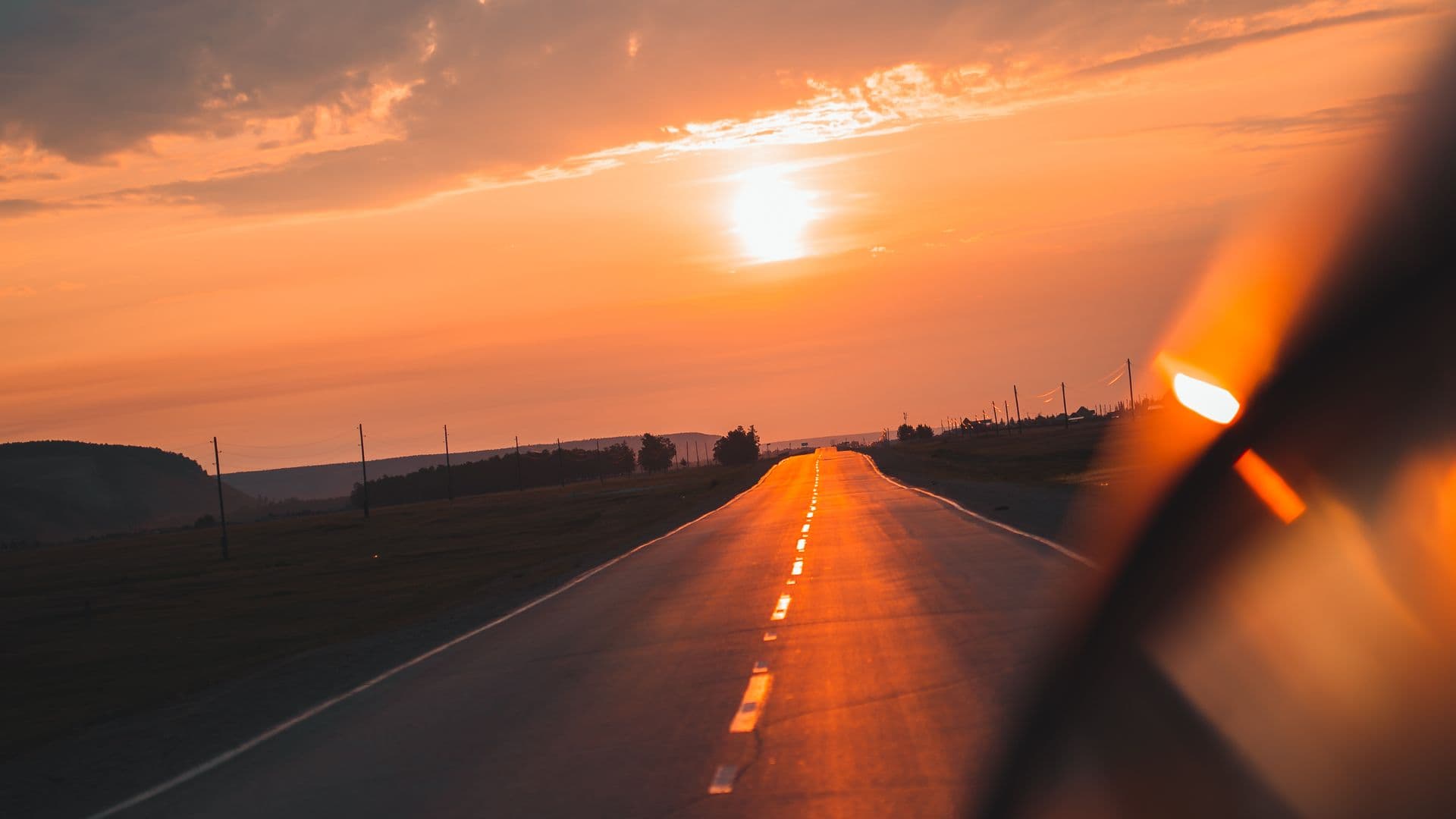 An open road glowing at sunset during a road trip