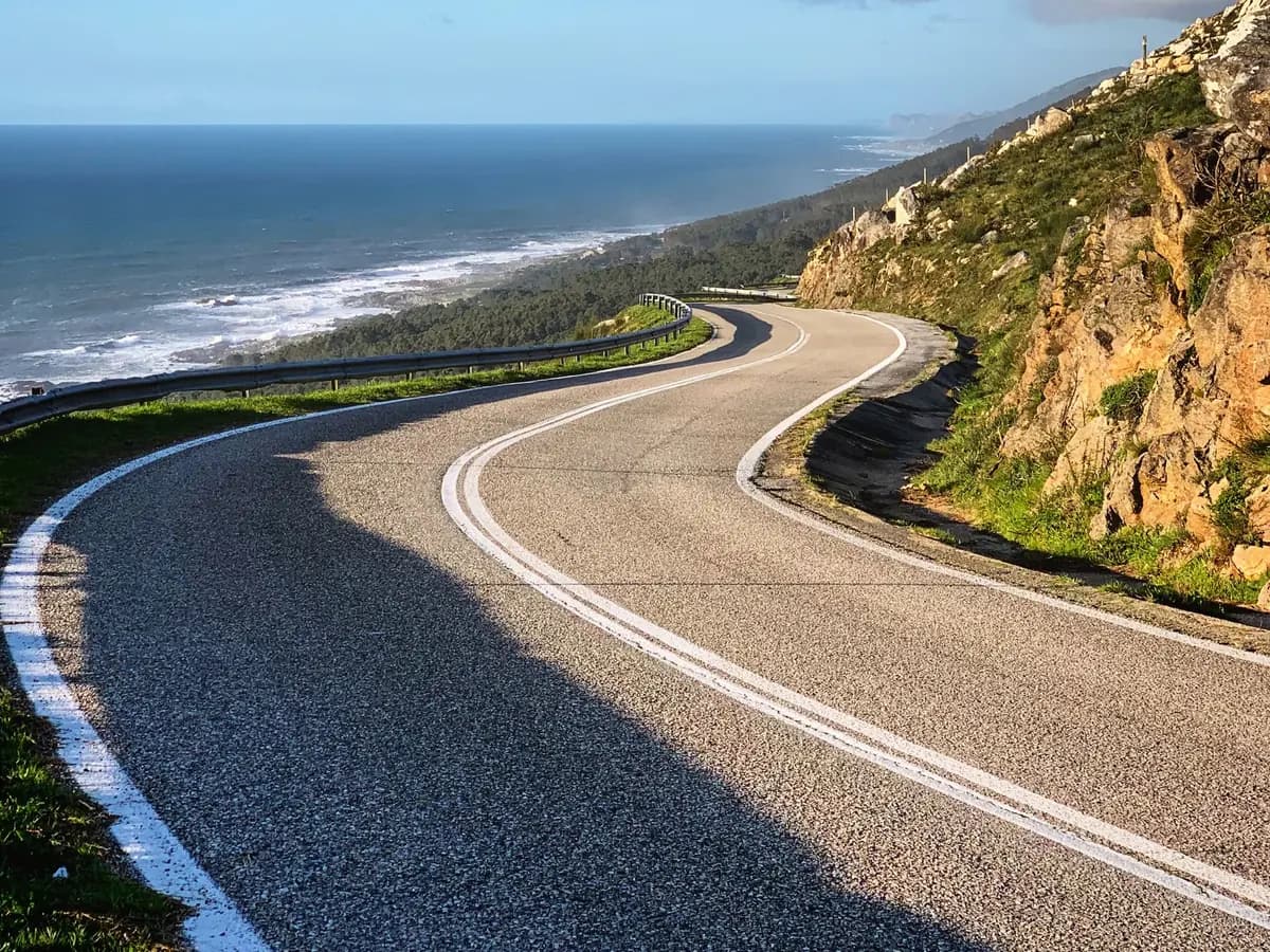 A winding coastal road overlooking the blue Atlantic Ocean