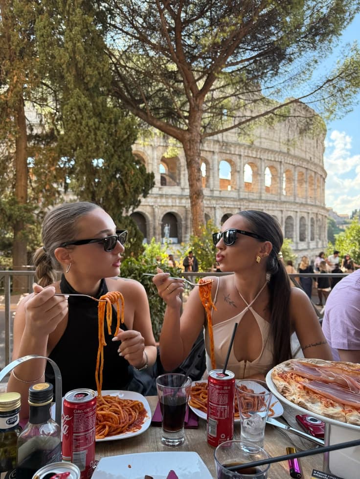 Friends enjoying pasta together on a weekend city break in Rome