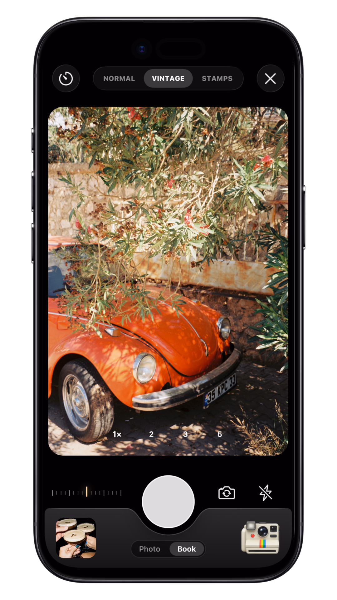 TripMemo Vintage Camera on iPhone showing a warm film photograph of a red classic car