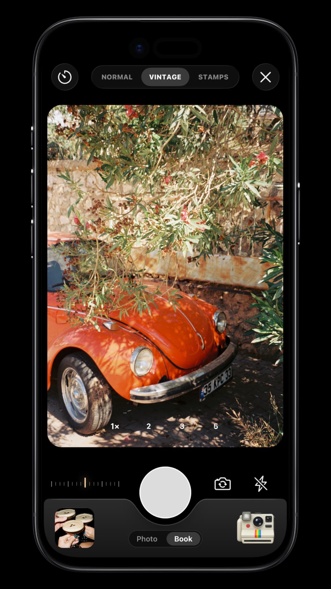 TripMemo Vintage Camera on iPhone showing a warm film photograph of a red classic car