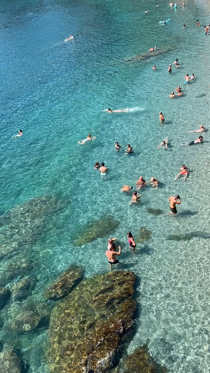 Swimmers in a turquoise cove